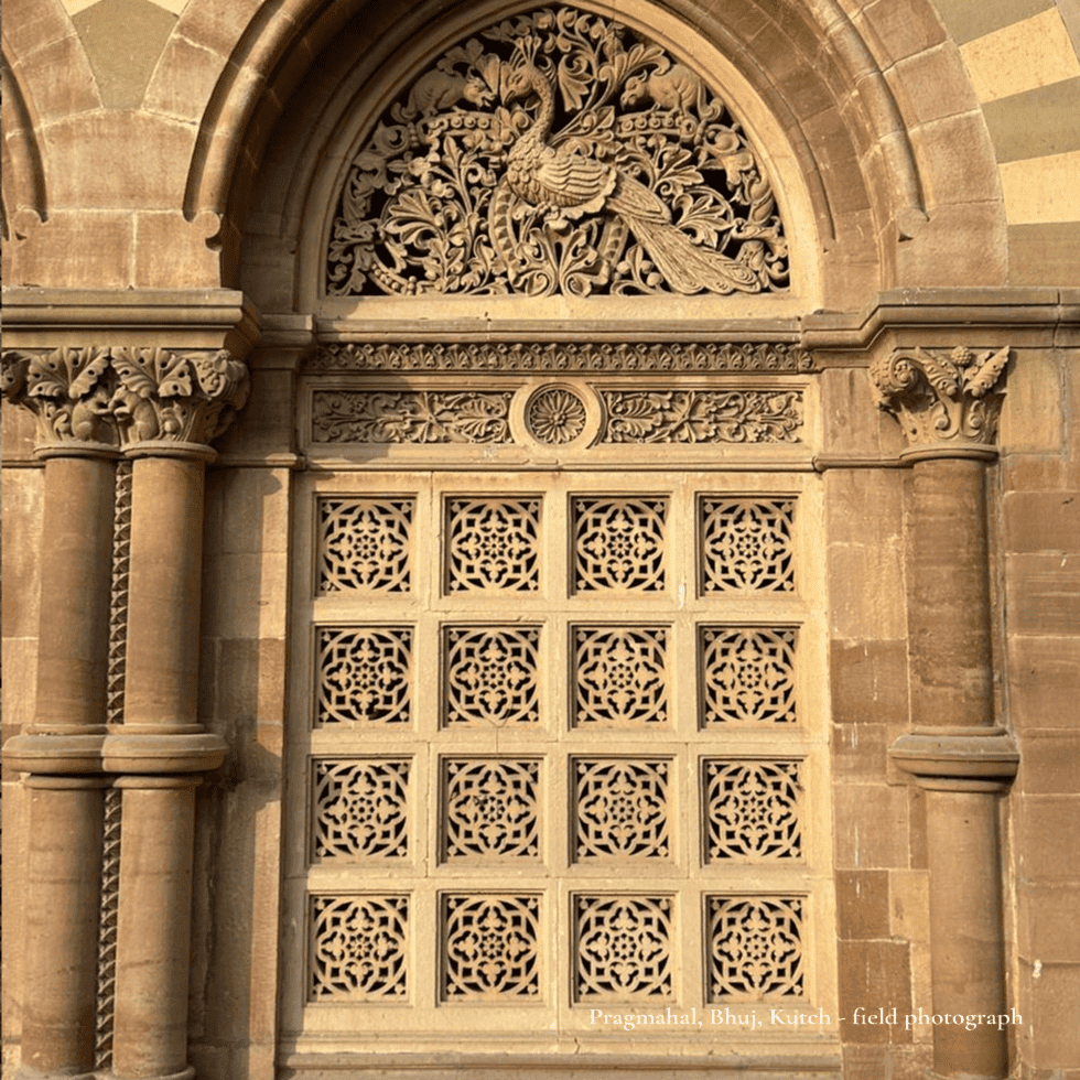 Detailed wooden window with floral and peacock carvings at Pragmahal, Kutch.
