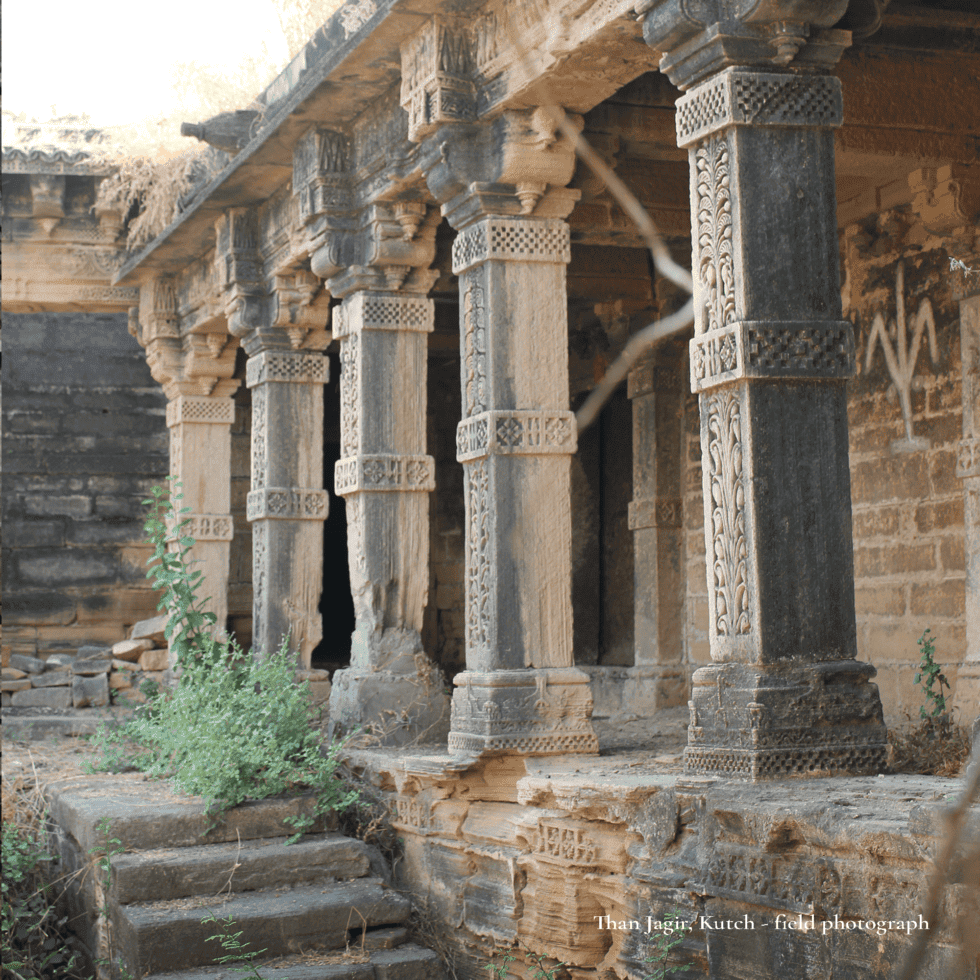 Ancient stone pillars at Than Jagir Kutch with intricate carvings.